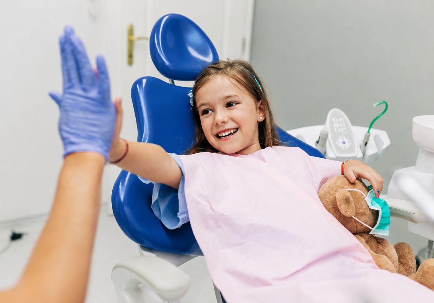 Child high-fiving the dentist